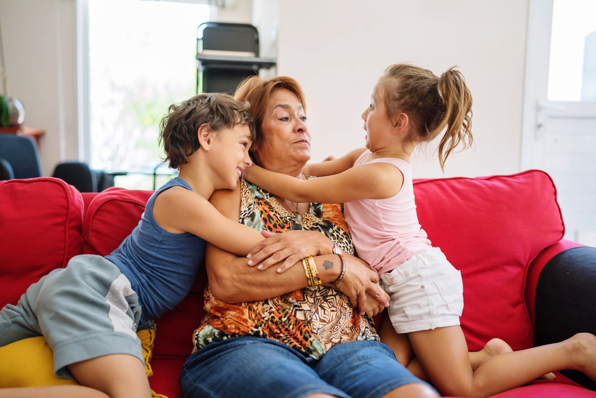 Grandmother Getting Hugs from Her Grandchildren